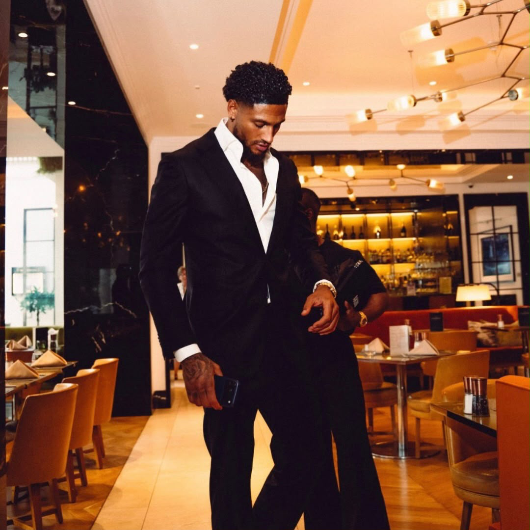 Maduka Emil Okoye in a black suit
